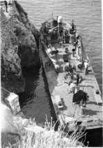 PT-215, a Higgins 78-footer of Motor Torpedo Boat Squadron 15 (MTBRon 15), tied up in Blue Grotto, Capri, Italy in Mar 1944.