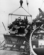 PT-325, an Elco 80-footer of Motor Torpedo Boat Squadron 21 (MTBRon 21) being hoisted aboard PT Boat tender USS Cyrene in San Pedro Bay, Leyte, Philippines, Jan 1945.