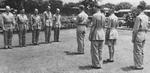 Colonel William E. Bergen reading medal citations while Lieutenant General Joseph Stilwell and Major General F. C. Sibert looked on, India, mid-1942