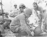 Treating a wounded US Marine, Guam, Jul-Aug 1944