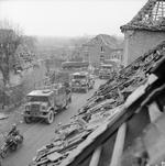 British convoy with CMP trucks passing the bombed out St. Laurentius church in Uedem, Germany, 2 Mar 1945. Note the long wheel-base CMP followed by a short wheel-base CMP.