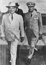 US President Harry Truman and Pacific Fleet Commander Admiral Arthur Radford walking to their car at the Wake Island conference, 16 Oct 1950. Note lines from early wirephoto transmission “noise.”