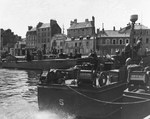 US Navy PT-199, a 78-foot Higgins motor torpedo boat, tied up with US Coast Guard 83-foot patrol boats along the waterfront at Cherbourg, France, 30 Aug 1944.