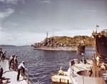 Cruiser USS St Louis departing Tulagi Harbor, Solomon Islands, 12 Jul 1943. The bow of fleet oiler USS Lackawanna is visible on the right.