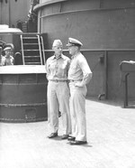 Admiral Raymond Spruance (left) speaking with Captain Carl Holden, commanding officer of USS New Jersey on the New Jersey’s foredeck at Majuro, Marshall Islands, 8 Apr 1944. Admiral Nimitz was also on board.
