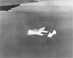 A P-38J with the 27th Fighter Squadron escorting a formation of B-24 Liberators from the 451st Bomb Group over Italy, 1944.