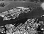 Aerial view of Ford Island in Pearl Harbor, Hawaii, 7 Jan 1941. Note the Pearl Harbor Naval Operating Base in the foreground and the carrier USS Lexington (Lexington-class) on the far side of Ford Island.