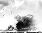 View from the Aiea Naval Hospital of anti-aircraft bursts nearly forming an umbrella over Pearl Harbor, Hawaii during the Japanese air attack, 7 Dec 1941. The thick smoke, center, is from the USS Arizona.
