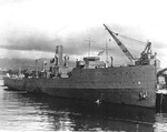 Minelayer USS Oglala, sunk in the Japanese attack on Pearl Harbor, 7 Dec 1941, at the piers of the Pearl Harbor Navy Yard in Dec 1942 after receiving initial repairs, Pearl Harbor, Hawaii.