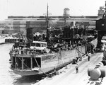 Minelayer USS Oglala, sunk in the Japanese attack on Pearl Harbor, 7 Dec 1941, at the piers of the Pearl Harbor Navy Yard in late 1942 soon after being refloated, Pearl Harbor, Hawaii.