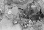 Sergeant Chestnut of US 5332nd Brigade (Provisional) with radio and supplies, Burma, 1945