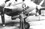 A crew chief with the 51st Fighter Squadron in front of the P-38J Lightning “Rebel” at Howard Field, Panama Canal Zone, 1944-45.