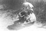 Members of US 5332nd Brigade (Provisional) Leo Tynan with local civilian, Lashio Airfield, Burma, 1945
