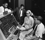 Donald Cropper, K. C. Krishnan, Grace Hopper, and Norman Rothberg working with a UNIVAC computer, circa 1960