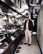 A warrant officer inspecting food service line aboard USS Proteus while at Mare Island Naval Shipyard, California, United States, Nov 1972