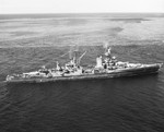 USS Portland in the Panama area while en route from the Pacific combat area to the US east coast, 12 Oct 1945. Note men crowded on her decks, and the long "homeward bound" pennant flying from her mainmast.