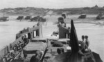 USS LCT-535 unloading vehicles onto a Normandie beach, France, 1944