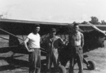 Sergeant Bev Cole, Lieutenant Sittner, Corporal Pierce of US 5332nd Brigade (Provisional) at Landis air strip with a Piper L-4 Grasshopper aircraft, Kachin, Burma, Dec 1944