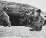2nd Lieutenant Donald Rusling, Captain Donald Garrett, 2nd Lieutenant Lester Bartils, and 2nd Lieutenant Glenn Hunter at a bomb shelter, Yontan Airfield, Okinawa, Japan, 1945