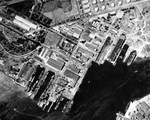 Straight down aerial view of the Pearl Harbor Navy Yard and drydocks, 16 Oct 1941. There are two battleships at the Navy Yard piers. Note Drydock #2 still under construction.