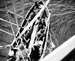 A boarding party shoves off from United States Coast Guard cutter Spencer to board the U-175 after the sub was forced to the surface by depth charges, North Atlantic, 500 nautical miles WSW of Ireland, 17 Apr 1943.