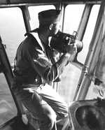 A United States Navy photographer in the gondola of a K-class airship based at Lakehurst, New Jersey, United States, 14 Oct 1943.