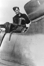 An armorer loading 13mm ammunition into the twin Rheinmetall MG131 guns in the upper fuselage of a Focke Wulf Fw-190A of Fighter Wing One (Jagdgeschwader 1), probably in France, circa 1944.