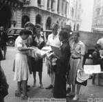 Recently freed internees of Stanley Internment Camp purchasing newspapers, Hong Kong, 12 Sep 1945