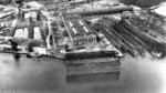 Building hall (center), floating drydock (foreground), slips (right), and other facilities of Flensburger Schiffbau, Flensburg, Germany, 1940s