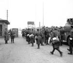The British Army entering the Bergen-Belsen Concentration Camp 15 Apr 1945 as German and Hungarian guards man the gate. On the right is a loudspeaker truck to inform inmates the camp was under British authority.