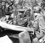 Field Marshal Bernard Montgomery, General Dwight Eisenhower, and General Omar Bradley examining a map on the side of a Jeep in Germany just west of the Rhine, 25 Mar 1945.
