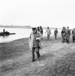 After crossing the Rhine, British Prime Minister Winston Churchill walking along the river’s eastern bank, 25 Mar 1945. Field Marshal Bernard Montgomery and some American generals can be seen in the background.