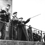 Field Marshal Bernard Montgomery visiting the Lion’s Mound in Belgium, a memorial to the 1815 Battle of Waterloo. Montgomery is listening to a guide describing the movements of the armies during the battle, 30 Oct 1944.