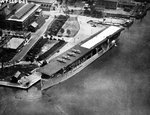 Aircraft carrier USS Langley (Langley-class) alongside the Washington Navy Yard, Washington, DC, United States, 3 Jul 1923. The white building at the photo’s top left is the present day National Museum of the Navy.