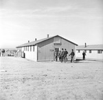 Men entering the cooperative canteen at Granada Relocation Center for deported Japanese-Americans (Camp Amache) in Colorado, United States, 9 Dec 1942.