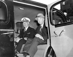 USS Saratoga’s new captain, DeWitt Ramsey (in uniform) and former captain, Archibald Douglas, in a 1937 Cadillac touring car, probably Puget Sound Naval Shipyard, Bremerton, Washington, United States, May 1942.