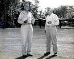 Army MGen Maxwell Murray and VAdm Aubrey Fitch at the Luganville Airfield at Espiritu Santo, New Hebrides awaiting first lady Eleanor Roosevelt on her tour of the South Pacific on behalf of the Red Cross, 14 Sep 1943.