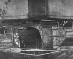 Damage to the Gallery Deck of the USS Ticonderoga as seen up and aft from the hanger deck. On 21 Jan 1945 a special attack plane crashed through the flight deck and through the gallery deck here. Feb 1945 photo.