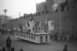 Lunar New Year parade, Chongqing, China, 15 Feb 1942; note Chinese and American national flags on float, Nationalist Party flag behind utility pole, Nationalist Party flags behind float