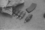 Captured Japanese Type 96 machine gun cartridge, Type 91 grenades, and unidentified grenade type, Hubei Province, China, 1942