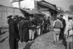 Chinese military personnel questioning refugees, Changde, Hunan Province, China, 25 Dec 1943