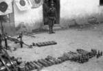 Chinese soldier guarding captured Japanese equipment, Changde, Hunan Province, China, 25 Dec 1943