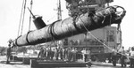 Japanese Type A Kō-hyōteki-class midget submarine used in the Pearl Harbor Attack recovered from the Keehi Lagoon off Honolulu, Hawaii, 6 Jul 1960. A floating heavy-lift crane is lowering the submarine onto a lighter.