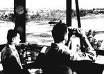 Controllers in the tower at Borinquen Field, Puerto Rico as a C-46 Commando lands on the runway, 1942.