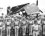 United States Marine Corps detachment aboard carrier USS Ticonderoga posing in front of a Grumman F6F-5 Hellcat Nightfighter of Air Group 87, Apr-May 1945 in the central Pacific.