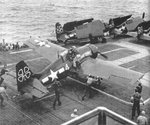 Eastern Aircraft FM2 Wildcats of Composite Squadron VC-93 on the flight deck of escort carrier USS Petrof Bay off Okinawa, 25 Mar 1945.