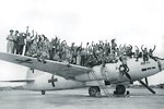 Celebratory photo of American servicemen on top of a Japanese G4M bomber painted in surrender markings at Ie Jima, 20 Aug 1945. This plane brought in Japanese envoys the day before and would take them out later this day