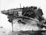 As seen from the repair ship USS Ajax, repairs underway to the forward flight deck of USS Bennington following damage during Typhoon Connie, San Pedro Bay, Leyte, Philippines, mid-Jul 1945.