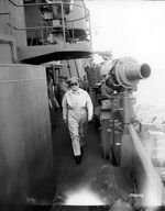 United States Army General Douglas MacArthur walking to the flag bridge on USS Nashville to observe landing operations at Hollandia in Humboldt Bay, New Guinea, 22 Apr 1944.
