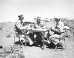 Brigadier General Franklin Hart, Major General Clifton Cates, and an unidentified officer (right, with glasses) at Iwo Jima, Japan, Feb-Mar 1945